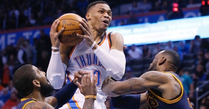 Oklahoma City Thunder guard Russell Westbrook (0) drives between Cleveland Cavaliers guard Kyrie Irving, left, and forward LeBron James during the third quarter of an NBA basketball game in Oklahoma City, Thursday, Feb. 9, 2017. Oklahoma City won 118-109. (AP Photo/Sue Ogrocki)