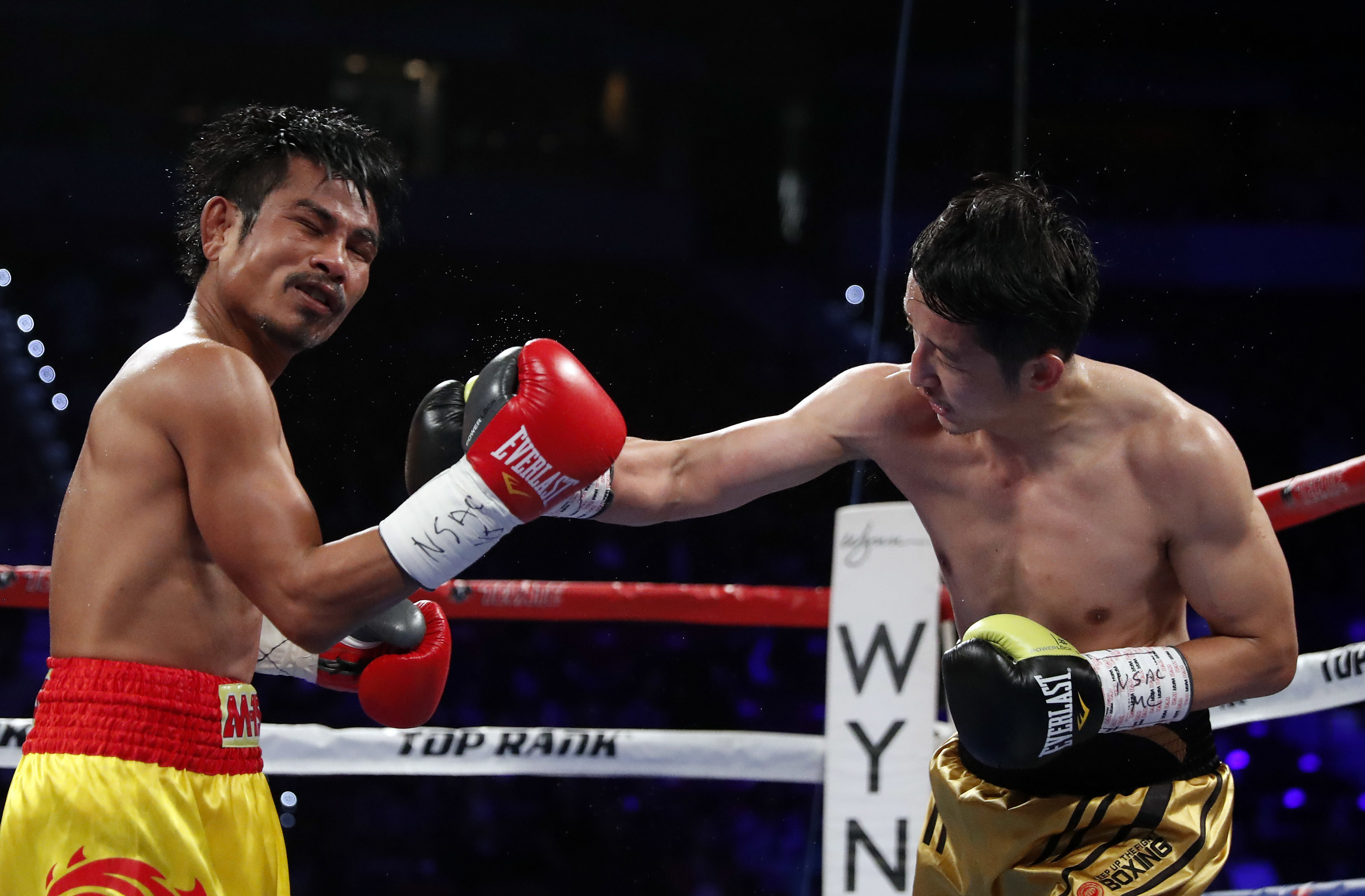 Zou Shiming, right, of China, punches Prasitak Phaprom, of Thailand, during their WBO flyweight title boxing match on Saturday, Nov. 5, 2016, in Las Vegas. Zou won by unanimous decision. (AP Photo/Isaac Brekken)