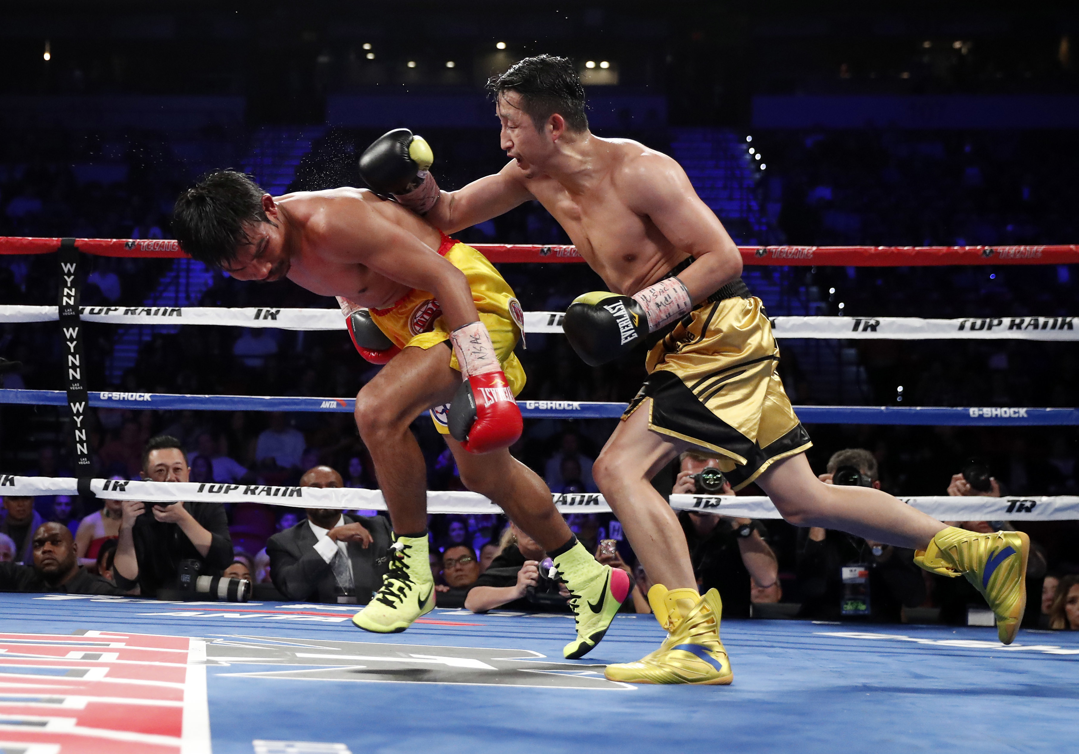 Zou Shiming, right, of China, punches Prasitak Phaprom, of Thailand, during their WBO flyweight title boxing match Saturday, Nov. 5, 2016, in Las Vegas. Zou won by unanimous decision. (AP Photo/Isaac Brekken)
