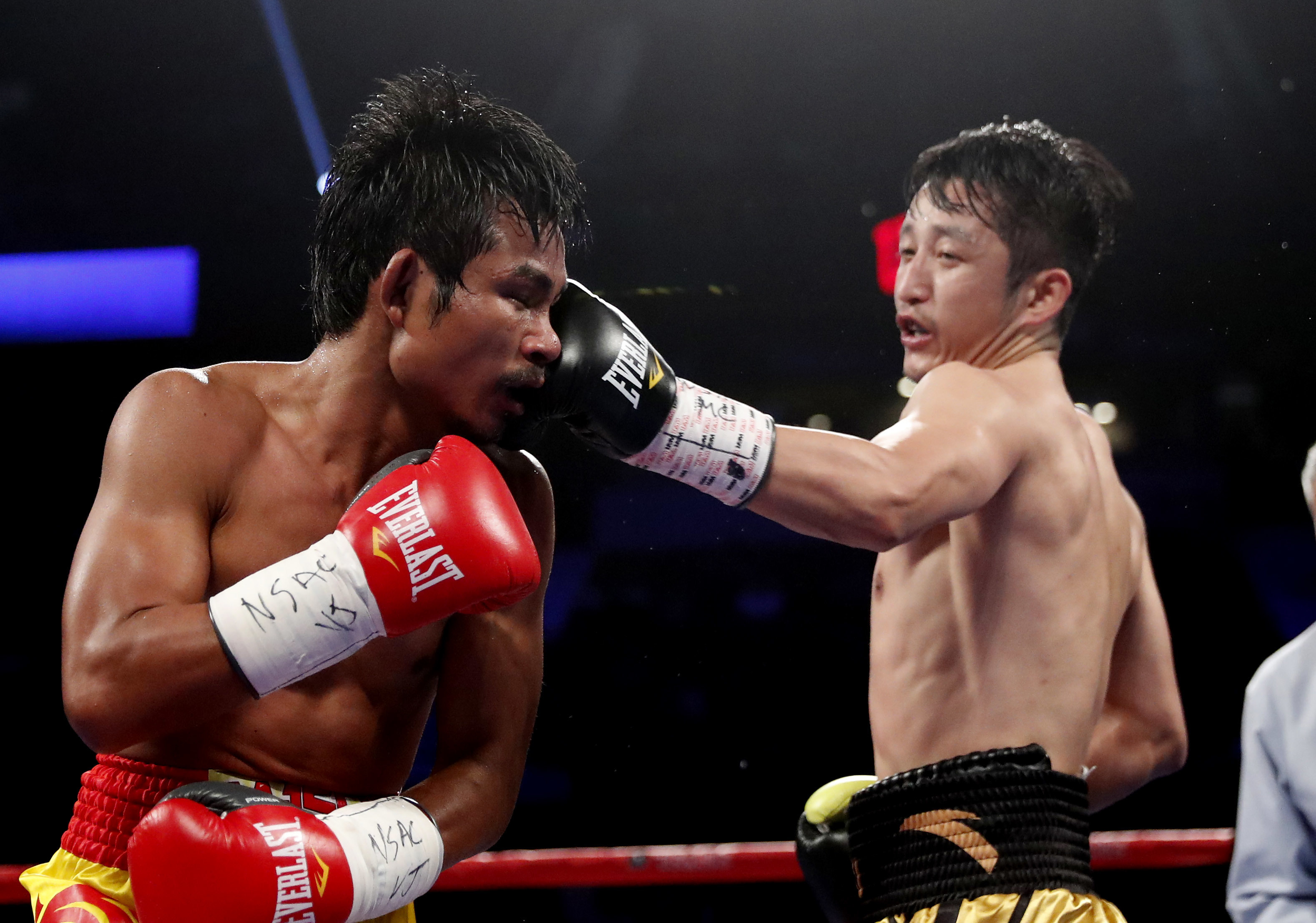 Zou Shiming, of China, right punches Prasitak Phaprom, of Thailand, during their WBO flyweight title boxing match on Saturday, Nov. 5, 2016, in Las Vegas. Zou won by unanimous decision. (AP Photo/Isaac Brekken)