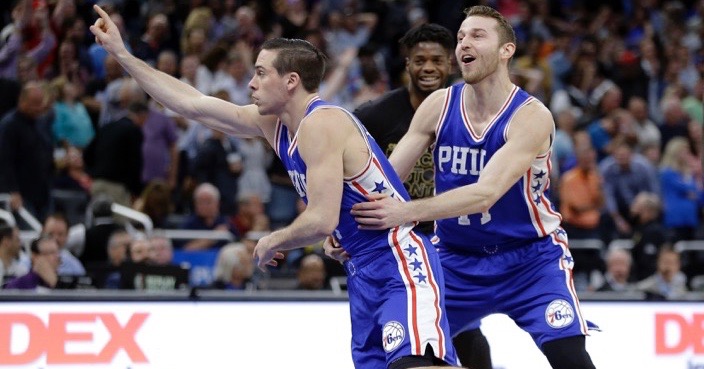 Philadelphia 76ers' TJ McConnell, left, celebrates with teammate Nik Stauskas  after making the game winning shot to defeat the Orlando Magic 112-111in an NBA basketball game, Thursday, Feb. 9, 2017, in Orlando, Fla.  (AP Photo/John Raoux)