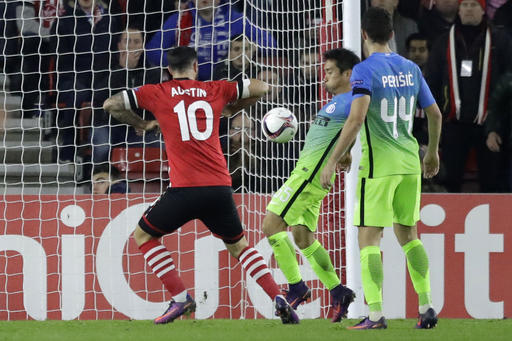 A shot on goal by Southampton's Dusan Tadic deflects off the body of Inter Milan's Yuto Nagatomo, second right, into the net to give Southampton a 2-1 lead during the Europa League group K stage soccer match between Southampton and Internazionale at St. Mary's Stadium in Southampton, England, Thursday, Nov. 3, 2016. (AP Photo/Matt Dunham)