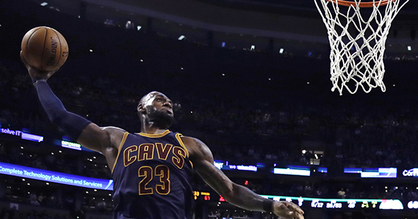 Cleveland Cavaliers forward LeBron James (23) lines up a dunk against Boston Celtics center Al Horford (42) during the third quarter of an NBA basketball game in Boston, Wednesday, March 1, 2017. (AP Photo/Charles Krupa)