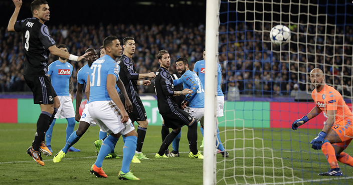 Real Madrid's Sergio Ramos, center, scores his side's first goal during the Champions League round of 16, second leg, soccer match between Napoli and Real Madrid at the San Paolo stadium in Naples, Italy, Tuesday March 7, 2017. (AP Photo/Andrew Medichini)
