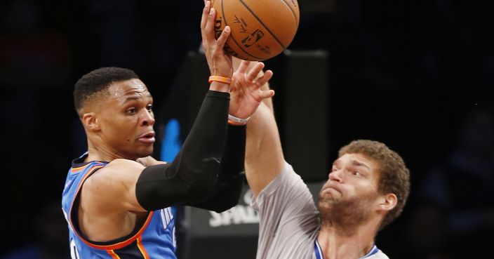 Oklahoma City Thunder guard Russell Westbrook (0) passes as Brooklyn Nets center Brook Lopez (11) defends in the second half of an NBA basketball game, Tuesday, March 14, 2017, in New York. Westbrook had 25 points, 11 rebounds and 19 assists for another triple double as the Thunder defeated the Nets 122-104. (AP Photo/Kathy Willens)