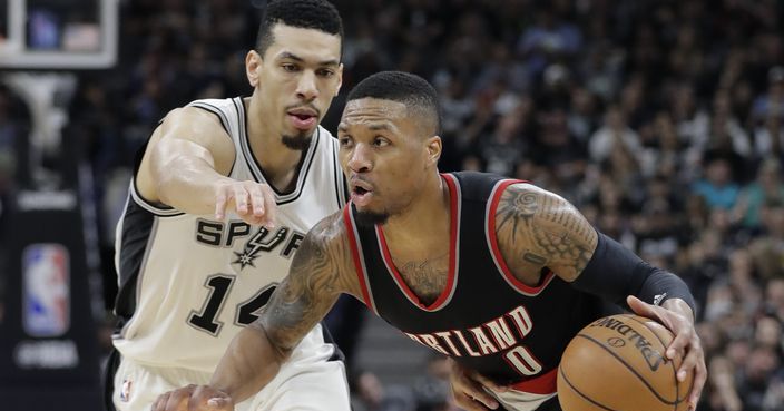 Portland Trail Blazers guard Damian Lillard (0) drives around San Antonio Spurs guard Danny Green (14) during the second half of an NBA basketball game, Wednesday, March 15, 2017, in San Antonio. Portland won 110-106. (AP Photo/Eric Gay)