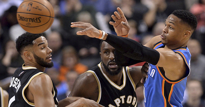 Oklahoma City Thunder guard Russell Westbrook (0) moves the ball past Toronto Raptors guard Cory Joseph (6) and forward Patrick Patterson (54) during the first half of an NBA basketball game Thursday, March 16, 2017, in Toronto. (Nathan Denette/The Canadian Press via AP)