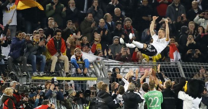 Germany's Lukas Podolski is thrown into the air after the friendly soccer match between Germany and England in Dortmund, Germany, Wednesday, March 22, 2017. Podolski retired from the national team after 130 matches and 49 scored goals. (AP Photo/Frank Augstein)