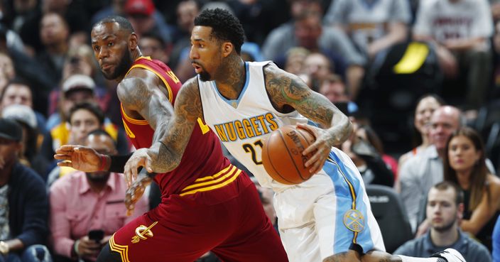 Denver Nuggets forward Wilson Chandler, right, drives against Cleveland Cavaliers forward LeBron James during the first half of an NBA basketball game Wednesday, March 22, 2017, in Denver. (AP Photo/David Zalubowski)