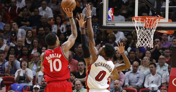 Toronto Raptors guard DeMar DeRozan (10) shoots under pressure from Miami Heat guard Josh Richardson (0) in the second half of an NBA basketball game, Thursday, March 23, 2017, in Miami. Toronto won the game 101-84. (AP Photo/Joe Skipper)