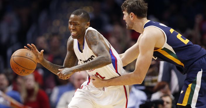 Los Angeles Clippers guard Jamal Crawford, left, is fouled by Utah Jazz center Jeff Withey, right, during the second half of an NBA basketball game, Saturday, March 25, 2017, in Los Angeles. The Clippers won 108-95. (AP Photo/Danny Moloshok)