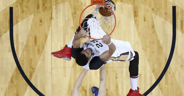 New Orleans Pelicans forward Anthony Davis (23) slam dunks ahead of Dallas Mavericks forward Dirk Nowitzki (41) in the first half of an NBA basketball game in New Orleans, Wednesday, March 29, 2017. (AP Photo/Gerald Herbert)