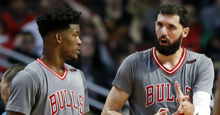 Chicago Bulls forward Nikola Mirotic, right, talks with guard/forward Jimmy Butler during the second half of an NBA basketball game against the Cleveland Cavaliers Thursday, March 30, 2017, in Chicago. (AP Photo/Nam Y. Huh)