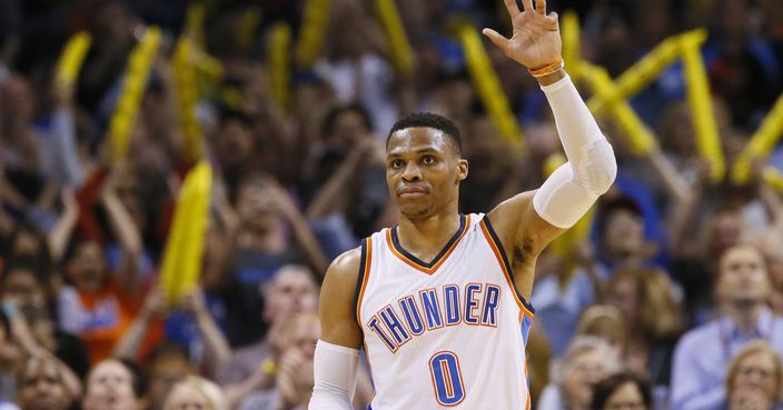 Oklahoma City Thunder guard Russell Westbrook (0) waves to the crowd after tying the record for triple-doubles in a season in the third quarter of an NBA basketball game against the Milwaukee Bucks in Oklahoma City, Tuesday, April 4, 2017. (AP Photo/Sue Ogrocki)