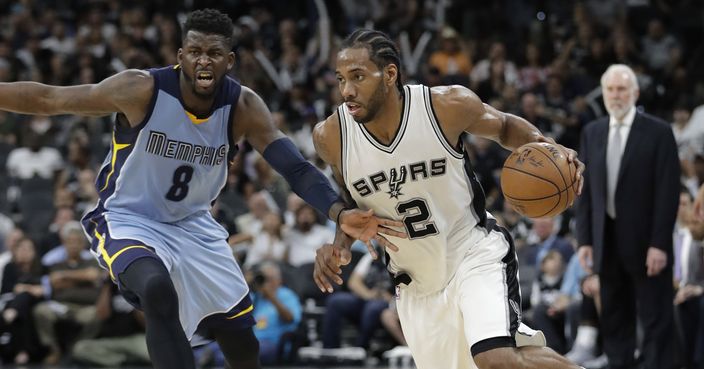 San Antonio Spurs forward Kawhi Leonard (2) drives around Memphis Grizzlies forward James Ennis III (8) during the second half in Game 2 of a first-round NBA basketball playoff series, Monday, April 17, 2017, in San Antonio. San Antonio won 96-82.(AP Photo/Eric Gay)