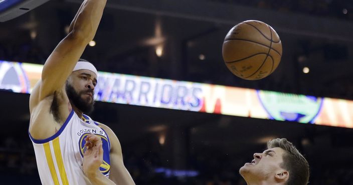 Golden State Warriors' JaVale McGee dunks over Portland Trail Blazers' Meyers Leonard during the first half in Game 2 of a first-round NBA basketball playoff series Wednesday, April 19, 2017, in Oakland, Calif. (AP Photo/Marcio Jose Sanchez)