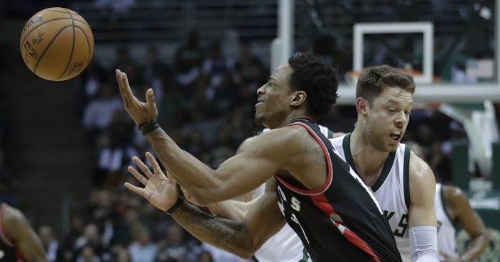 Milwaukee Bucks' Matthew Dellavedova fouls Toronto Raptors' DeMar DeRozan during the first half of Game 4 of an NBA first-round playoff series basketball game Saturday, April 22, 2017, in Milwaukee. (AP Photo/Morry Gash)