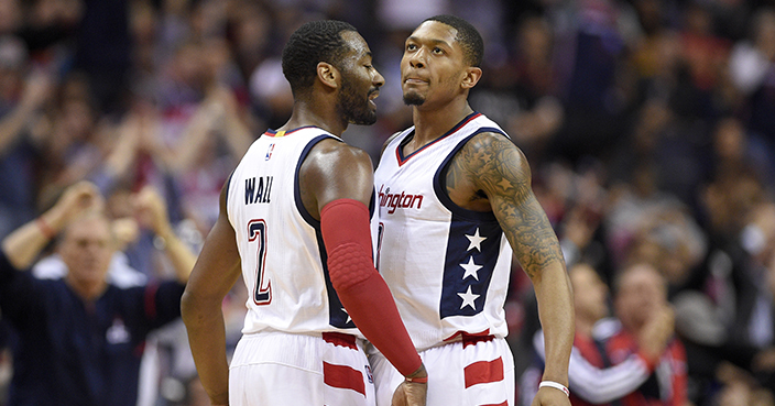 Washington Wizards guards John Wall (2) and guard Bradley Beal chest-bump during the second half in Game 5 of the team's first-round NBA basketball playoff series against the Atlanta Hawks, Wednesday, April 26, 2017, in Washington. The Wizards won 103-99. (AP Photo/Nick Wass)