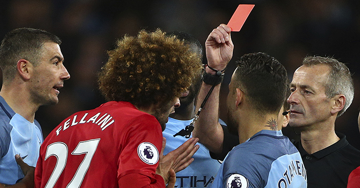 Manchester United's Marouane Fellaini, left, is sent off by given a red card during the English Premier League soccer match between Manchester City and Manchester United at the Etihad Stadium in Manchester, England,Thursday, April 27, 2017.(AP Photo/Dave Thompson)