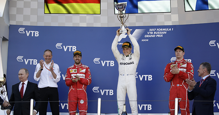 Mercedes driver Valtteri Bottas of Finland, center celebrates his victory at the Formula One Russian Grand Prix at the 'Sochi Autodrom' circuit, with second placed Ferrari driver Sebastian Vettel, left, of Germany and thirs Ferrari driver Kimi Raikkonen of Finland, in Sochi, Russia, Sunday, April. 30, 2017. (AP Photo/Pavel Golovkin)