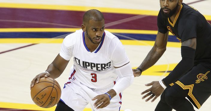 Los Angeles Clippers' Chris Paul (3) drives around Cleveland Cavaliers' Kyrie Irving (2) during the first half of an NBA basketball game Thursday, Dec. 1, 2016, in Cleveland. (AP Photo/Ron Schwane)