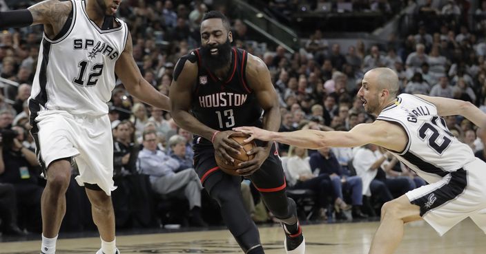 Houston Rockets guard James Harden (13) drives between San Antonio Spurs forward LaMarcus Aldridge (12) and guard Manu Ginobili (20) during the first half of Game 1 of a second-round NBA playoff series basketball game, Monday, May 1, 2017, in San Antonio. (AP Photo/Eric Gay)