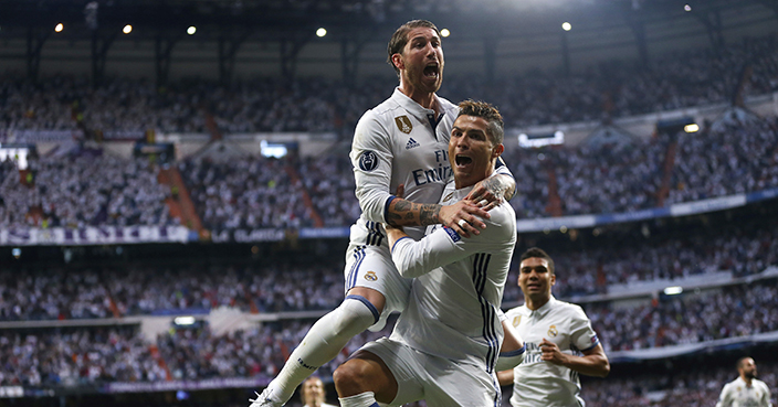 Real Madrid's Cristiano Ronaldo celebrates with Real Madrid's Sergio Ramos, left, after scoring the opening goal during the Champions League semifinals first leg soccer match between Real Madrid and Atletico Madrid at Santiago Bernabeu stadium in Madrid, Spain, Tuesday May 2, 2017. (AP Photo/Daniel Ochoa de Olza)