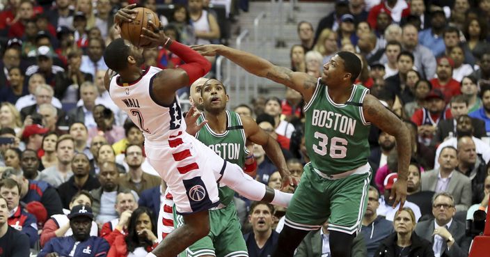 Washington Wizards guard John Wall (2) loses control as he tries to shoot past Boston Celtics guard Marcus Smart (36) during the first half of a second-round NBA playoff series basketball game, Thursday, May 4, 2017, in Washington. (AP Photo/Andrew Harnik)