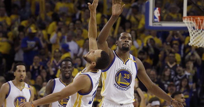 Golden State Warriors guard Stephen Curry, center left, and forward Kevin Durant (35) celebrate during the second half of Game 1 of the NBA basketball Western Conference finals against the San Antonio Spurs in Oakland, Calif., Sunday, May 14, 2017. (AP Photo/Jeff Chiu)