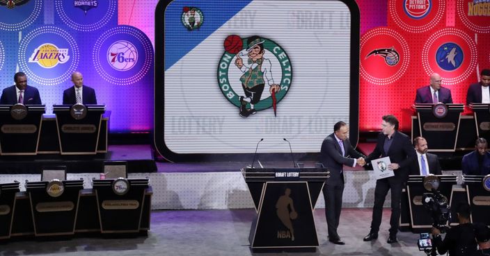 NBA Deputy Commissioner Mark Tatum, front left, shakes hands with Boston Celtics co-owner Wyc Grousbeck, right, after the Celtics won the first pick at the NBA basketball draft lottery Tuesday, May 16, 2017, in New York. (AP Photo/Frank Franklin II)