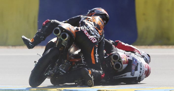 Moto3 rider Adam Norrodin of Malasia, left, and Moto3 rider Tatsuki Suzuki of Japan crash during the French Grand Prix's race, in Le Mans, western France, Sunday, May 21, 2017. (AP Photo/David Vincent)