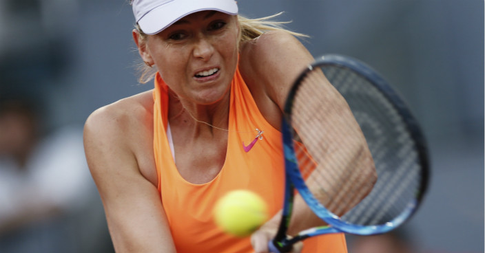 Maria Sharapova from Russia returns a ball to Eugenie Bouchard from Canada during a Madrid Open tennis tournament match in Madrid, Spain, Monday, May 8, 2017. Bouchard won 7-5, 2-6 and 6-4. (AP Photo/Francisco Seco)