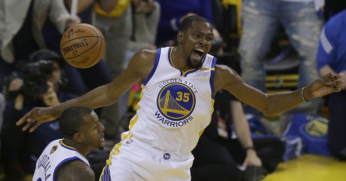 Golden State Warriors forward Kevin Durant (35) reacts after dunking against the Cleveland Cavaliers next to forward Andre Iguodala during the first half of Game 1 of basketball's NBA Finals in Oakland, Calif., Thursday, June 1, 2017. (AP Photo/Ben Margot)