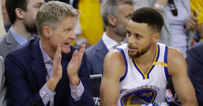 Golden State Warriors head coach Steve Kerr, left, talks with guard Stephen Curry during the second half of Game 2 of basketball's NBA Finals against the Cleveland Cavaliers in Oakland, Calif., Sunday, June 4, 2017. (AP Photo/Marcio Jose Sanchez)