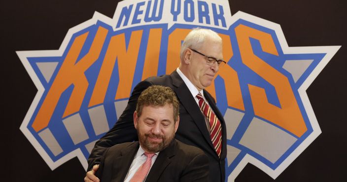 FILE - In this March 18, 2014, file photo, New York Knicks new team president Phil Jackson puts his hand on team owner James Dolan, seated, during a news conference where Jackson was introduced, at New York's Madison Square Garden. The Knicks and Jackson parted ways Wednesday morning, June 28, 2017, ending a three-year tenure that saw plenty of tumult and not a single playoff appearance.(AP Photo/Richard Drew, File)
