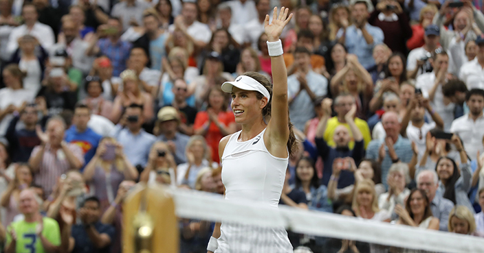 Britain's Johanna Konta celebrates after beating Romania's Simona Halep at the end of their Women's Quarterfinal Singles Match on day eight at the Wimbledon Tennis Championships in London Tuesday, July 11, 2017. (AP Photo/Alastair Grant)