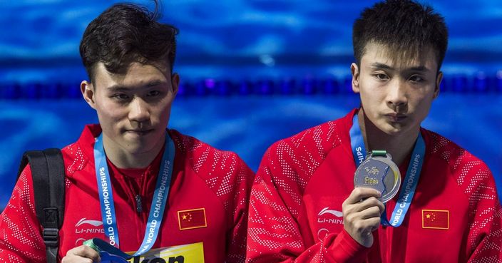 Silver medal winners Yuan Cao and Siyi Xie of China pose on the podium during the medal ceremony after the men's diving 3m synchro springboard final at the Swimming World Championships 2017 in Duna Arena in Budapest, Hungary, Saturday, July 15, 2017. (Zsolt Szigetvary/MTI via AP)