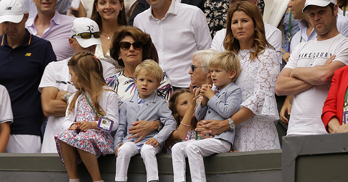 Mirka, the wife of Switzerland's Roger Federer sits in the players box with their children after he defeated Croatia's Marin Cilic to win the Men's Singles final match on day thirteen at the Wimbledon Tennis Championships in London Sunday, July 16, 2017. (AP Photo/Alastair Grant)