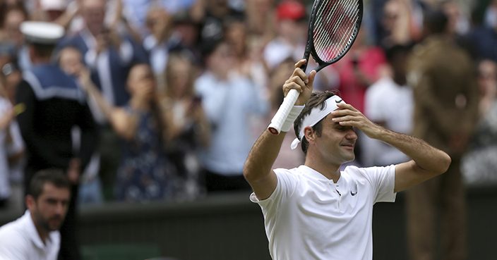 Switzerland's Roger Federer celebrates after defeating Croatia's Marin Cilic, left, to win the Men's Singles final match on day thirteen at the Wimbledon Tennis Championships in London Sunday, July 16, 2017. (AP Photo/Tim Ireland)
