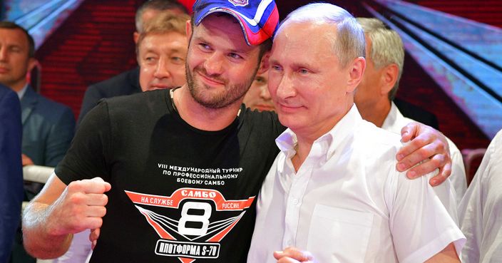 In this Tuesday, Aug. 8, 2017 photo, Russian President Vladimir Putin, right, poses for a photo with Champion of Russia Dmitry Bikrev after an international tournament in professional Sambo Plotforma S-70 in the Black Sea resort of Sochi, Russia. (Alexei Druzhinin, Sputnik, Kremlin Pool Photo via AP)