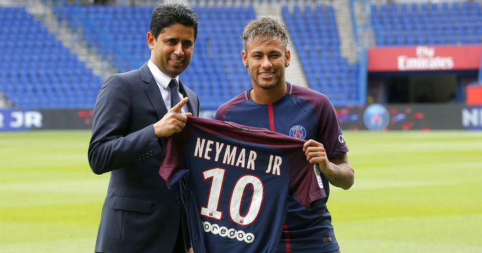 Brazilian soccer star Neymar holds his team shirt as he stands with the chairman of Paris Saint-Germain Nasser Al-Khelaifi following a press conference in Paris Friday, Aug. 4, 2017. Neymar arrived in Paris on Friday the day after he became the most expensive player in soccer history when completing his blockbuster transfer to Paris Saint-Germain from Barcelona for 222 million euros ($262 million).(AP Photo/Michel Euler)