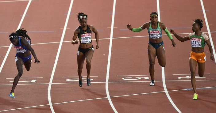 United States' Tori Bowie, left, crosses the finish line to win the Women's 100 final ahead of Ivory Coast's Marie-Josee Ta Lou, right, during the World Athletics Championships in London Sunday, Aug. 6, 2017. (AP Photo/Martin Meissner)