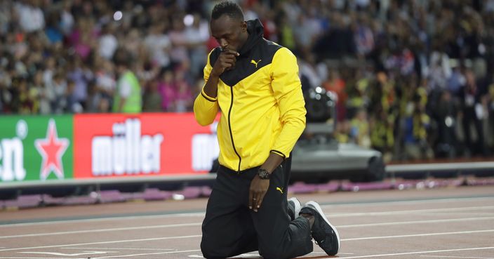 Jamaica's Usain Bolt kneels down during a lap of honor at the end of the World Athletics Championships in London Sunday, Aug. 13, 2017. (AP Photo/Matt Dunham)