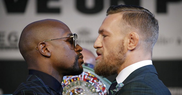 Floyd Mayweather Jr., left, and Conor McGregor pose for photographers during a news conference Wednesday, Aug. 23, 2017, in Las Vegas. The two are scheduled to fight in a boxing match Saturday in Las Vegas. (AP Photo/John Locher)