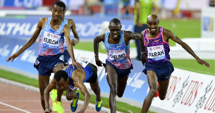 Mo Farah of Great Britain crosses the finish line as the winner next to second Paul Chelimo of United States, the falling Muktar Edris of Ethiopia as third and Yomif Kejelcha of Ethiopia as fourth, from right, in the 5000m Men, during the Weltklasse IAAF Diamond League international athletics meeting in the Letzigrund stadium in Zurich, Switzerland, Thursday, August 24, 2017. (KEYSTONE/Walter Bieri)