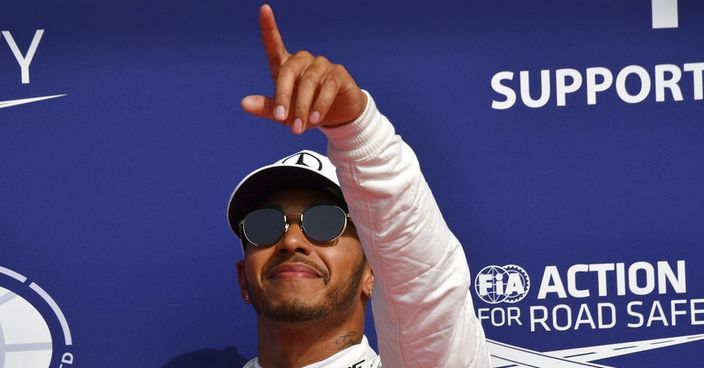 Mercedes driver Lewis Hamilton of Britain, right, stands on the podium with Ferrari driver Sebastian Vettel of Germany after the qualifying session ahead of the Belgian Formula One Grand Prix in Spa-Francorchamps, Belgium, Saturday, Aug. 26, 2017. Lewis Hamilton has secured pole position for the Belgian Grand Prix, equalling Michael Schumacher's record of 68 career poles. (AP Photo/Geert Vanden Wijngaert)