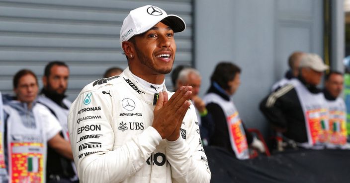Mercedes driver Lewis Hamilton of Britain celebrates at the end of the qualifying session for Sunday's Italian Formula One Grand Prix, at the Monza racetrack, Italy, Saturday, Sept.2, 2017. ewis Hamilton claims his 69th career pole position to break Michael Schumacher's Formula One record. (AP Photo/Antonio Calanni)