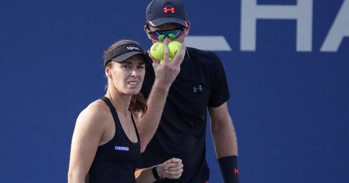 Martina Hingis, left, of Switzerland, and Jamie Murray, of Britain, talk before serving to Abigail Spears, of the United States, and Juan Sebastian Cabal, of Colombia, during a mixed doubles quarterfinal at the U.S. Open tennis tournament, Tuesday, Sept. 5, 2017, in New York. (AP Photo/Julio Cortez)
