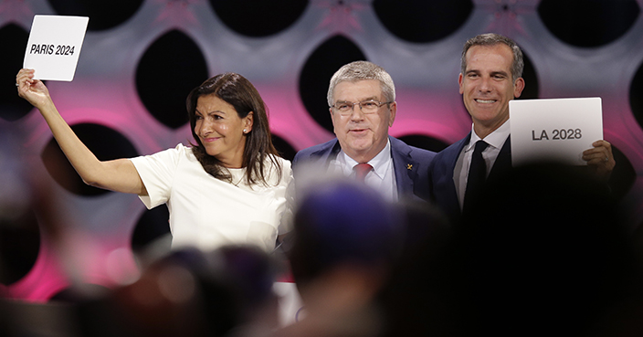 International Olympic Committee (IOC) President Thomas Bach stands between Paris Mayor Anne Hidalgo, left, and Los Angeles Mayor Eric Garrett at the end of the IOC session in Lima, Peru, Wednesday, Sept. 13, 2017. The IOC is voting to ratify Los Angeles as the host city of the 2028 Olympic and Paralympic Games and Paris as the host city of the 2024 Games during the IOC Session. (AP Photo/Martin Mejia)
