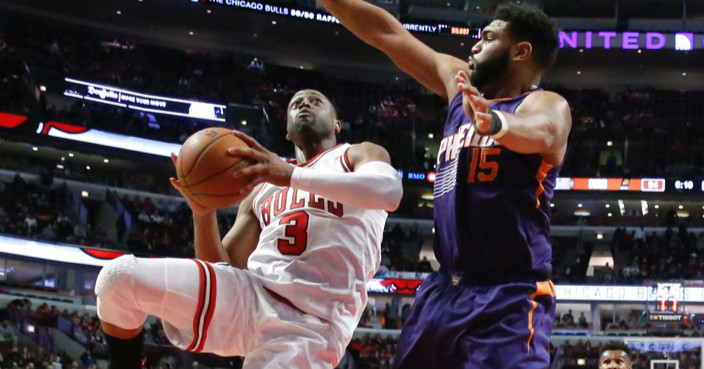 Chicago Bulls' Dwyane Wade (3) drives on Phoenix Suns' Alan Williams (15) during the second half of an NBA basketball game Friday, Feb. 24, 2017, in Chicago. The Bulls won in overtime 128-121. (AP Photo/Charles Rex Arbogast)